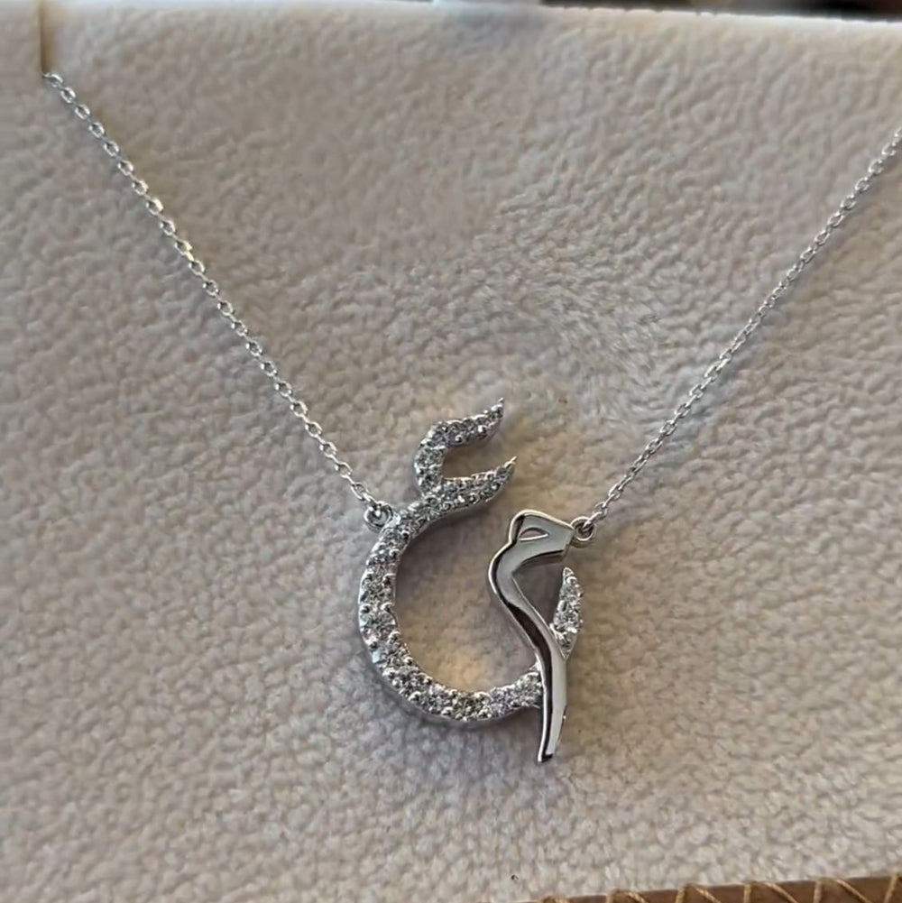 Diamond Arabic Initial Necklace by MUHVA STORE featuring a delicate chain and a personalized initial pendant with sparkling diamonds.