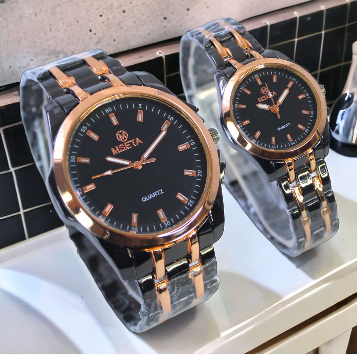 Muhva Store MSETA Couple Watch M-003 with matching silver-tone bands and round watch faces on a white background.