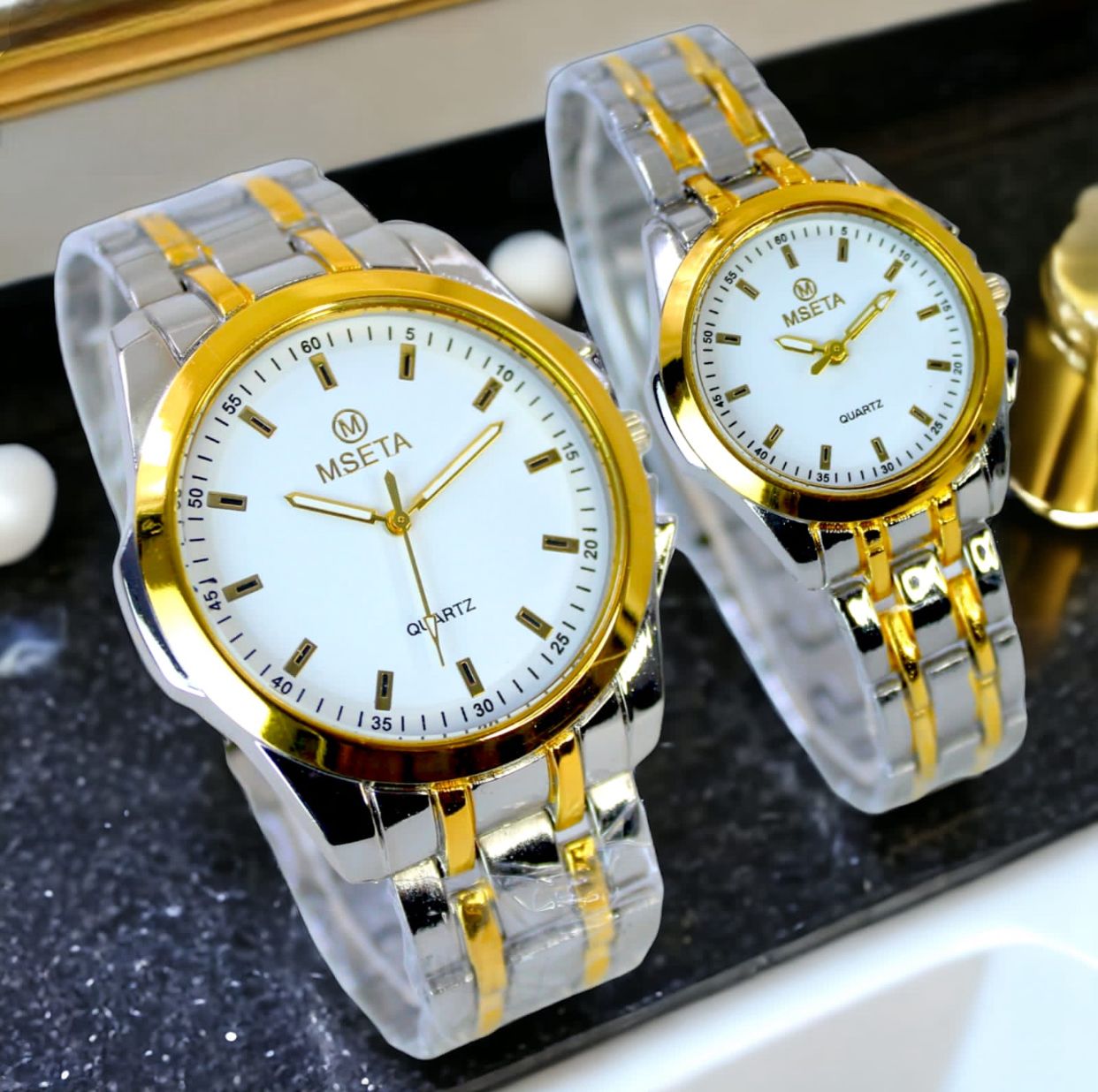 Muhva Store MSETA Couple Watch M-005 featuring matching stainless steel bands and elegant round watch faces for couples.