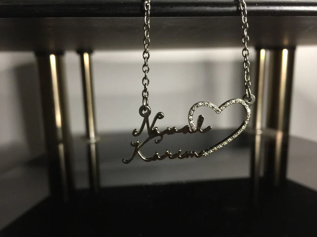Diamond double name necklace with heart pendant from MUHVA STORE, featuring personalized names and a sparkling diamond accent.