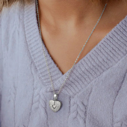 Personalized heart pendant with engraved details from MUHVA STORE, showcasing a close-up of the silver jewelry piece.