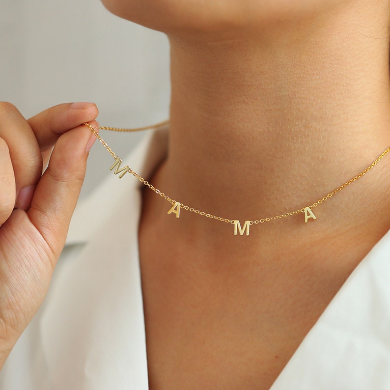 Personalized letter necklace by MUHVA STORE with a sleek chain and custom initial pendant on a white background.