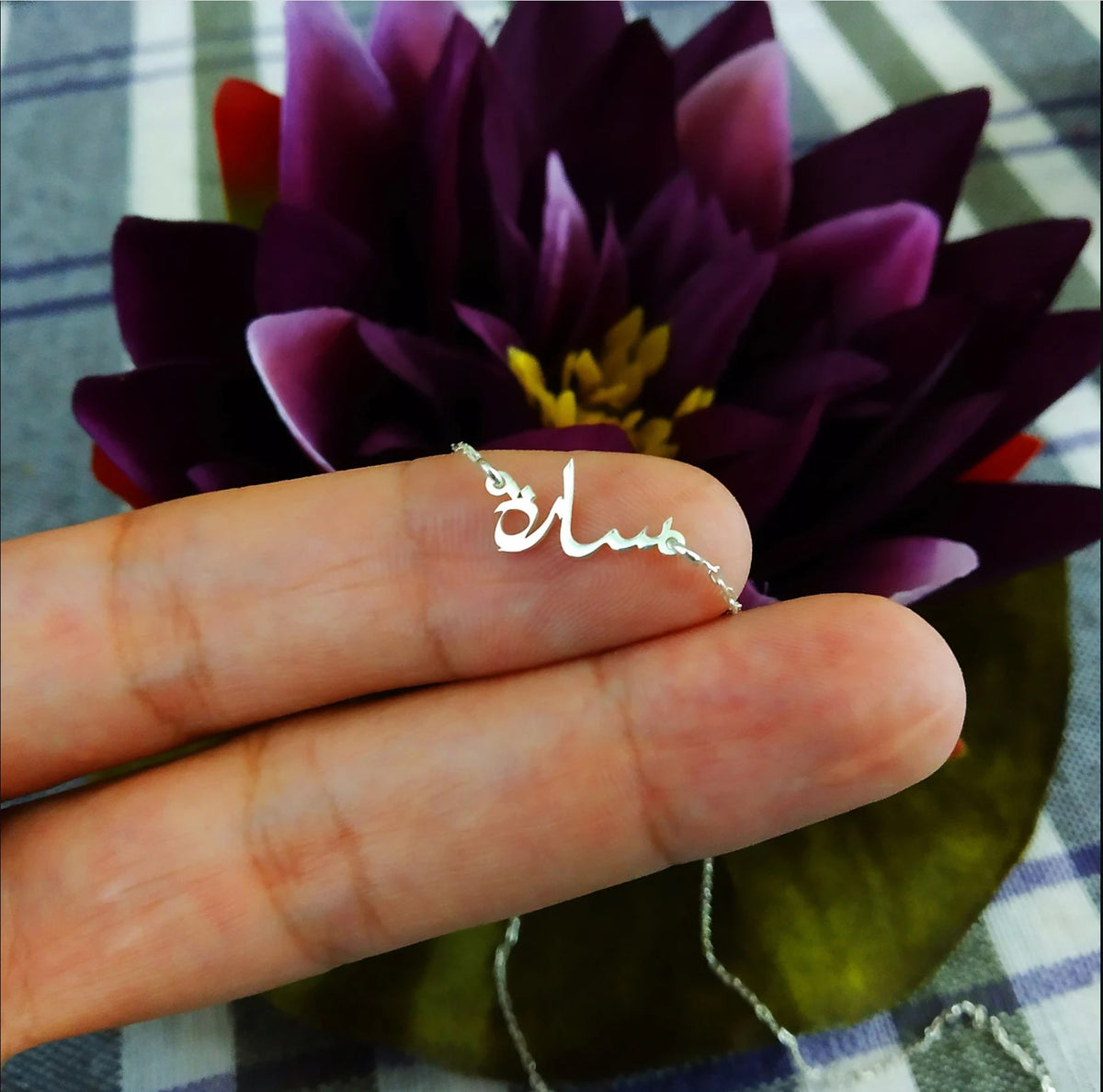 Tiny Arabic name necklace from MUHVA STORE featuring delicate gold chain and personalized Arabic script pendant.