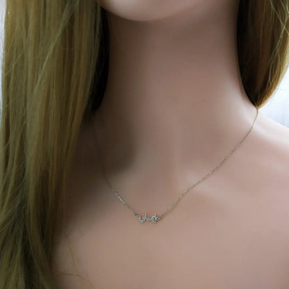 Tiny Arabic name necklace from MUHVA STORE featuring a delicate gold chain and personalized Arabic script pendant.
