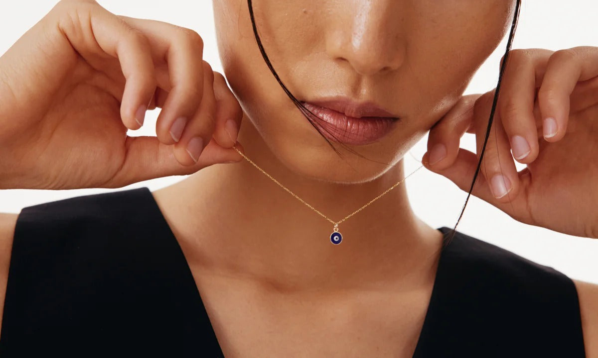 Evil Eye Pendant Necklace from MUHVA STORE featuring a blue and white protective eye charm on a silver chain.
