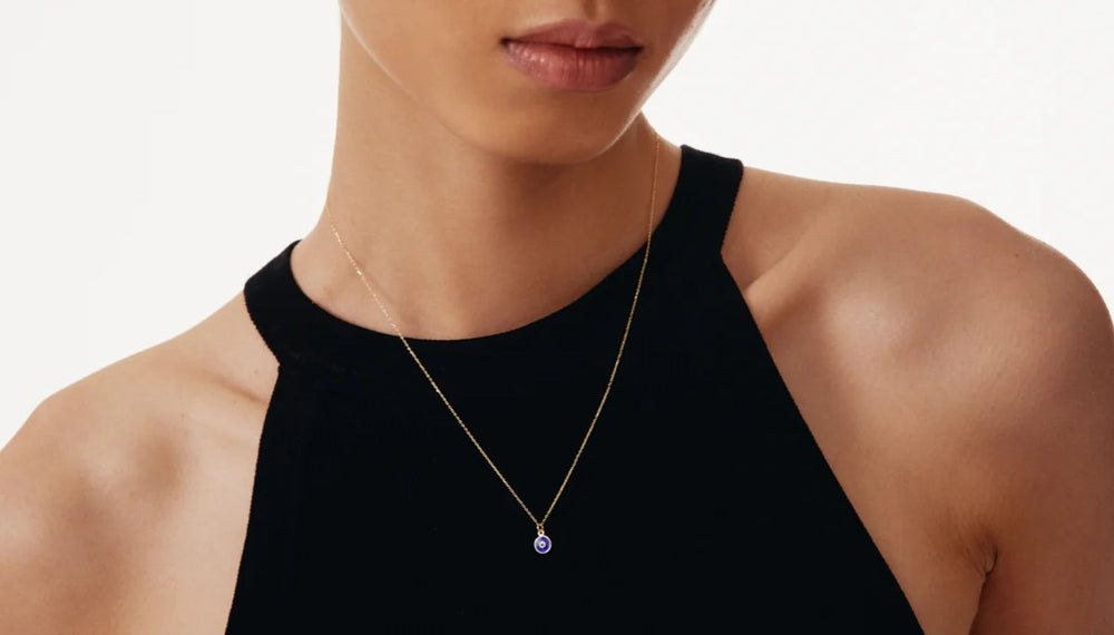 Silver evil eye pendant necklace from MUHVA STORE featuring a vibrant blue and white eye design on a delicate chain.