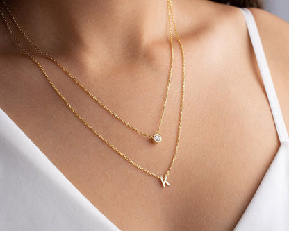 Gold diamond initial layer necklace with a delicate pendant, showcasing a personalized initial design from MUHVA STORE.