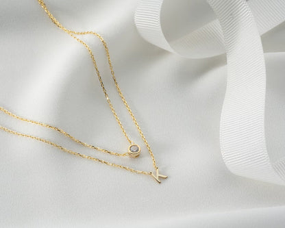 Gold diamond initial layer necklace with a pendant featuring a sparkling initial letter, stylish and elegant jewelry by MUHVA STORE