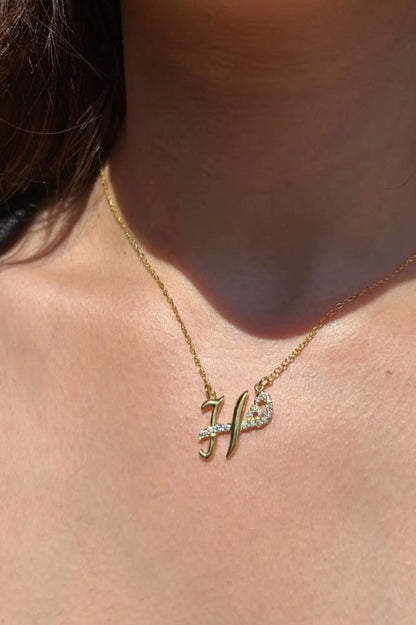 Custom duo initial necklace by MUHVA STORE with two personalized initial pendants on a delicate chain.