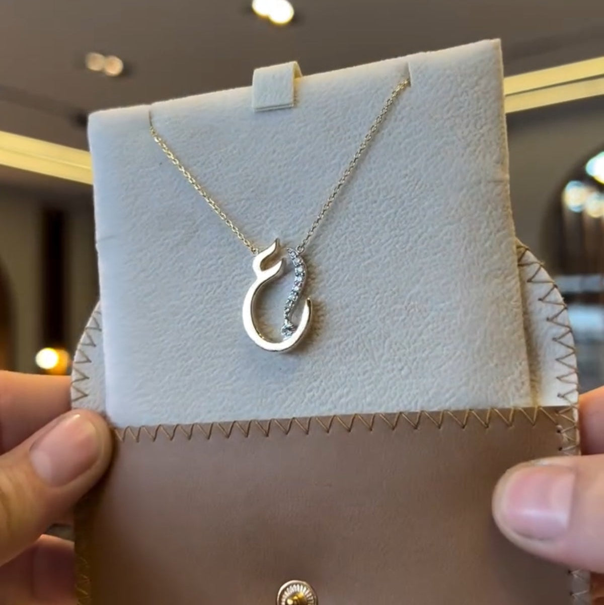 Gold Arabic initial necklace with diamond accents, featuring a delicate chain and personalized initial pendant from MUHVA STORE.