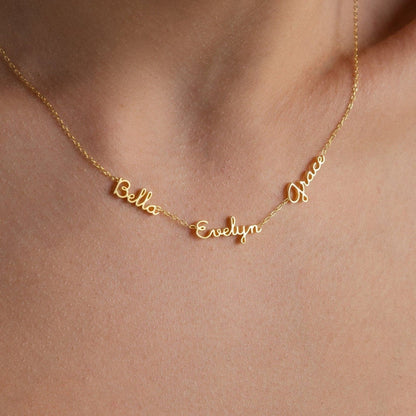 Tiny multiple name necklace by MUHVA STORE with delicate chain and personalized engraved names on silver or gold pendant.