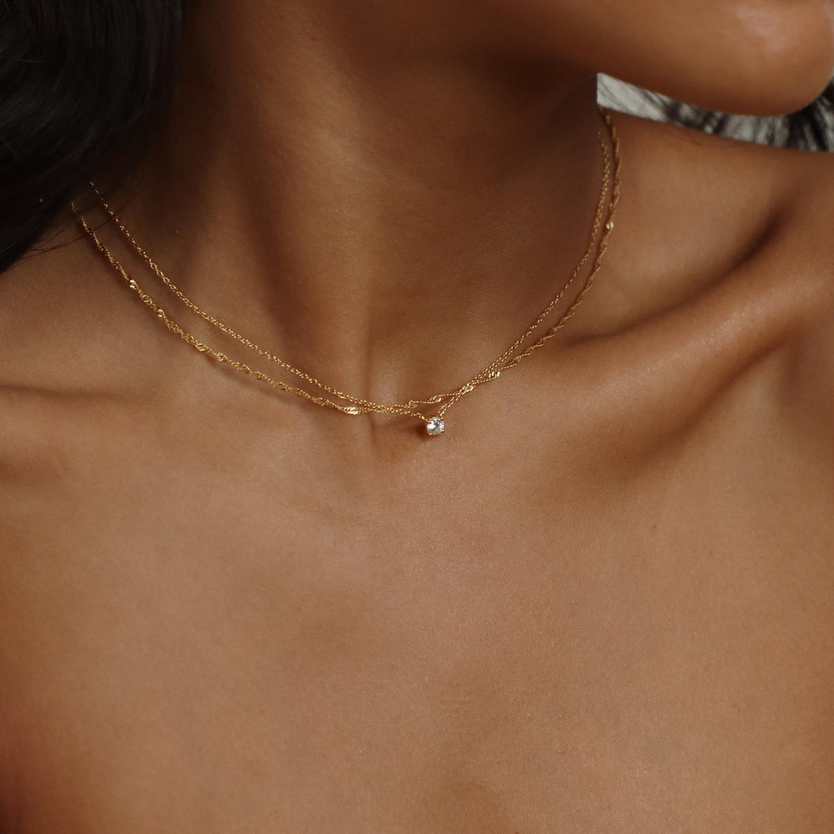 Dainty diamond pendant necklace from MUHVA STORE featuring a sparkling diamond on a delicate chain.