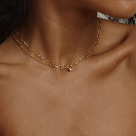Dainty diamond pendant necklace from MUHVA STORE featuring a sparkling diamond on a delicate chain.