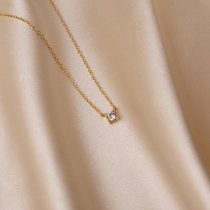 Dainty diamond pendant necklace with a small sparkling diamond on a delicate silver chain, stylish jewelry from MUHVA STORE