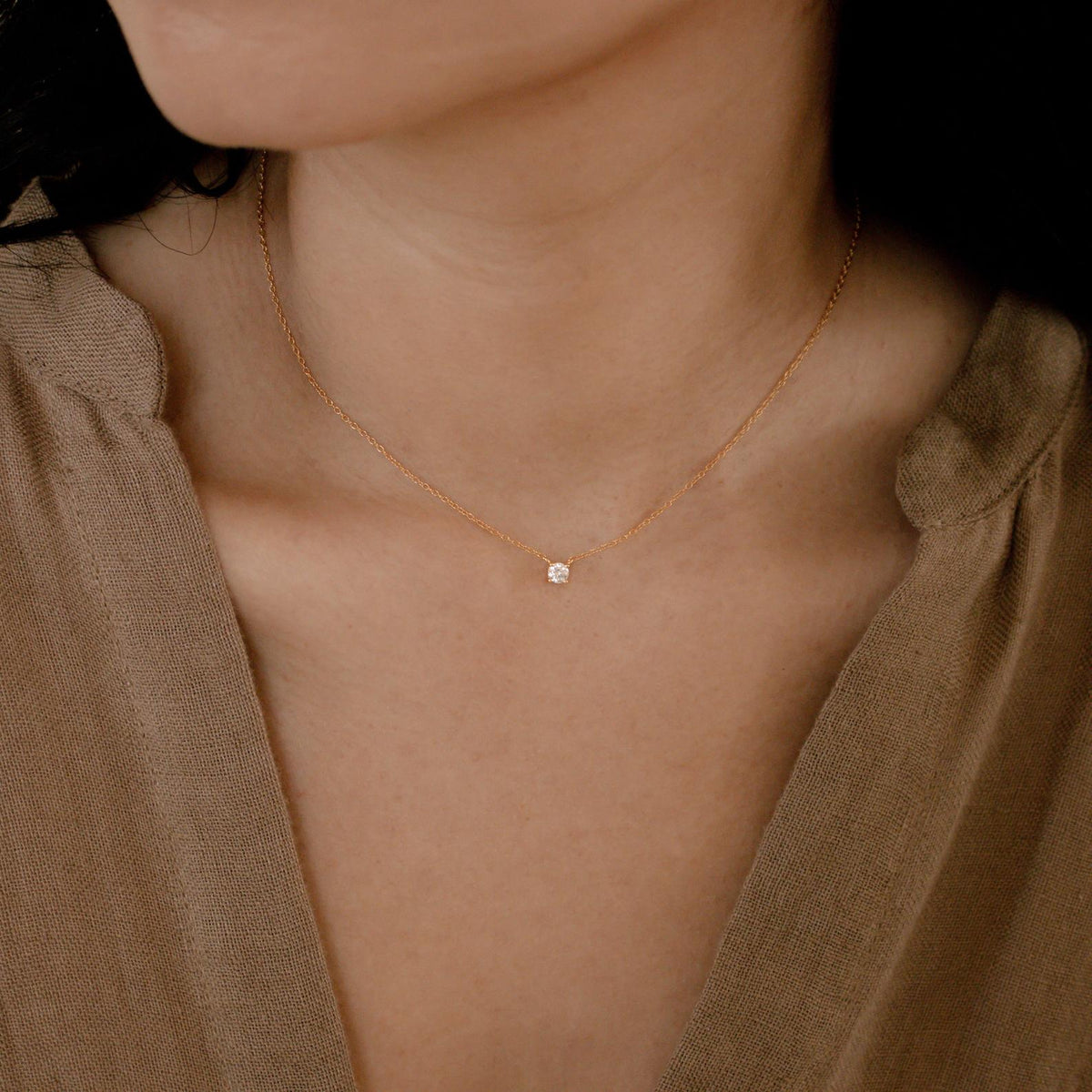 Dainty diamond pendant necklace with a small sparkling diamond on a delicate chain, by MUHVA STORE.