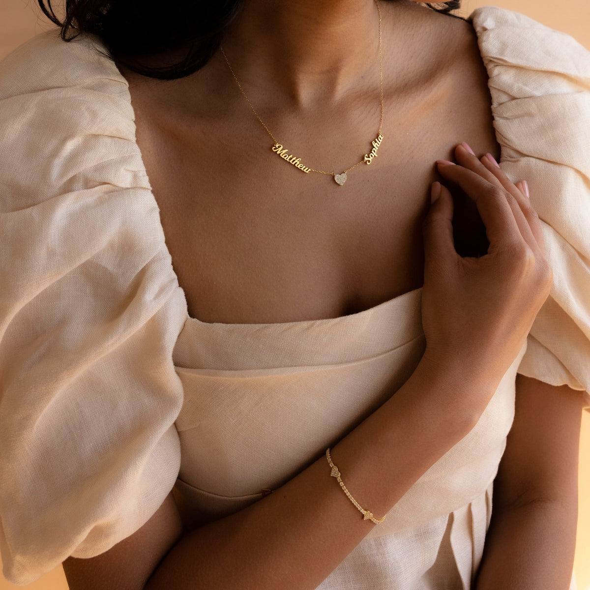 Personalized heart-shaped name necklace from MUHVA STORE with custom engraving, silver-tone pendant on a delicate chain.