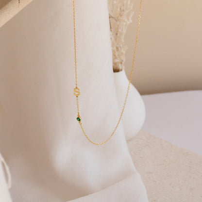 Sideways initial birthstone necklace by MUHVA STORE featuring a silver chain and a vertical initial pendant with a colorful birthstone.