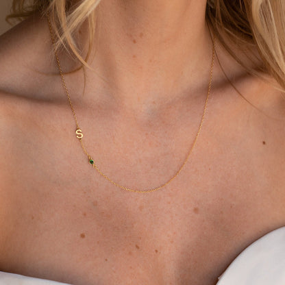 Gold sideways initial birthstone necklace with a sparkling gemstone and initial letter pendant, stylish jewelry by MUHVA STORE