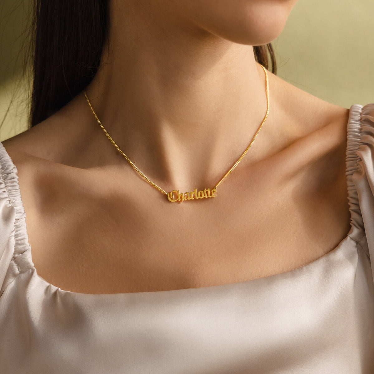 Old English name necklace by MUHVA STORE featuring a personalized gold pendant with intricate Old English script.