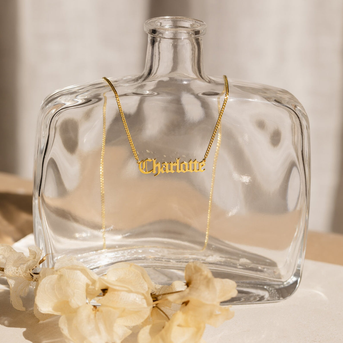 Old English style name necklace from MUHVA STORE featuring a personalized engraved pendant on a silver chain.