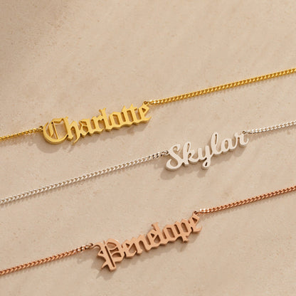 Old English name necklace by MUHVA STORE featuring a personalized engraved name in intricate Old English font on a silver chain.