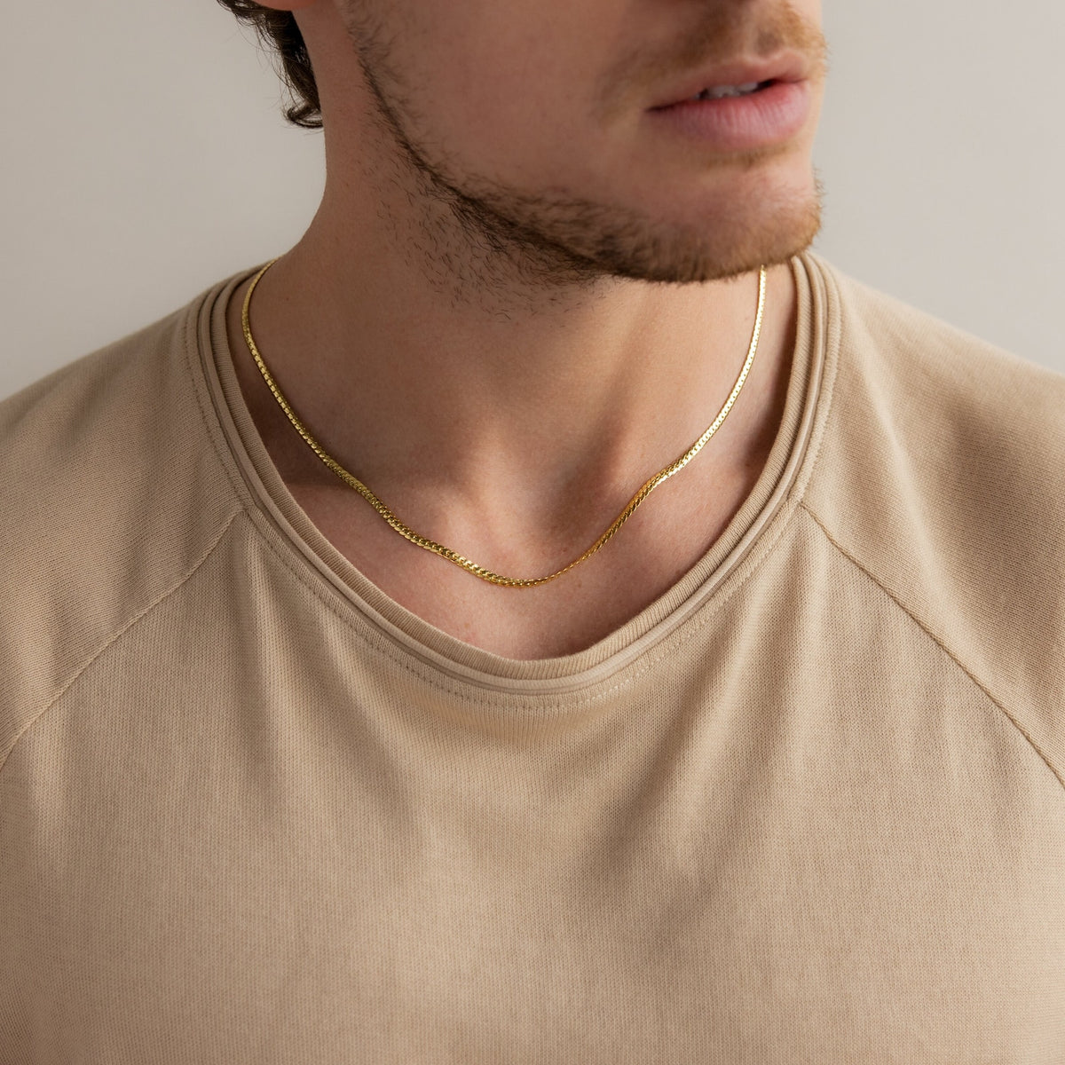 Men's snake chain necklace from MUHVA STORE showcasing a sleek, shiny silver design with a smooth, continuous link pattern.