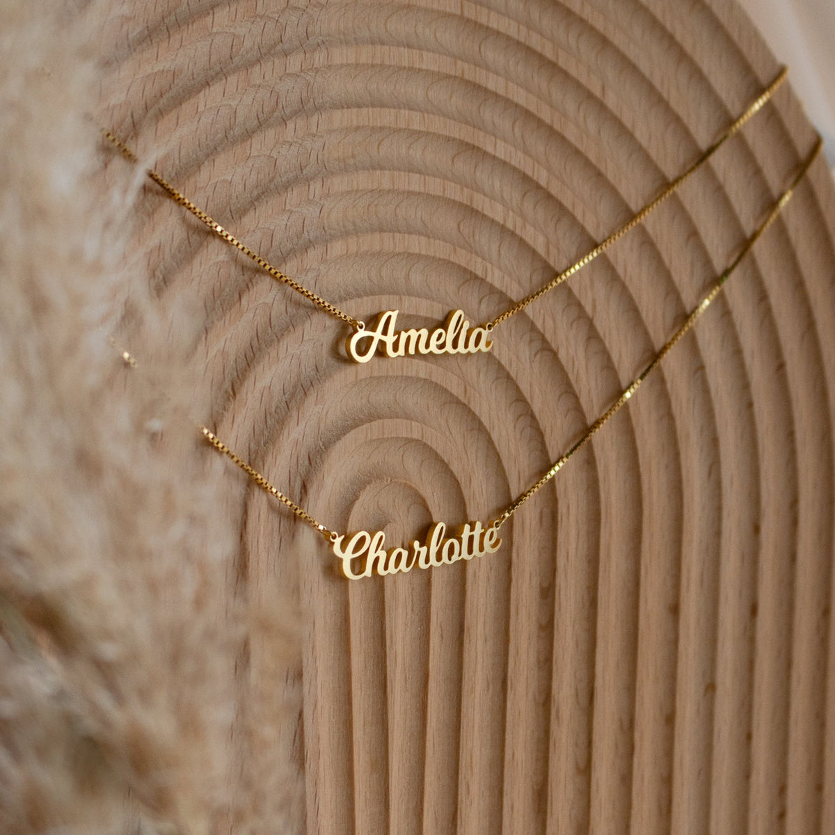 Personalized double name necklace with gold chain and two custom name pendants, designed by MUHVA STORE.