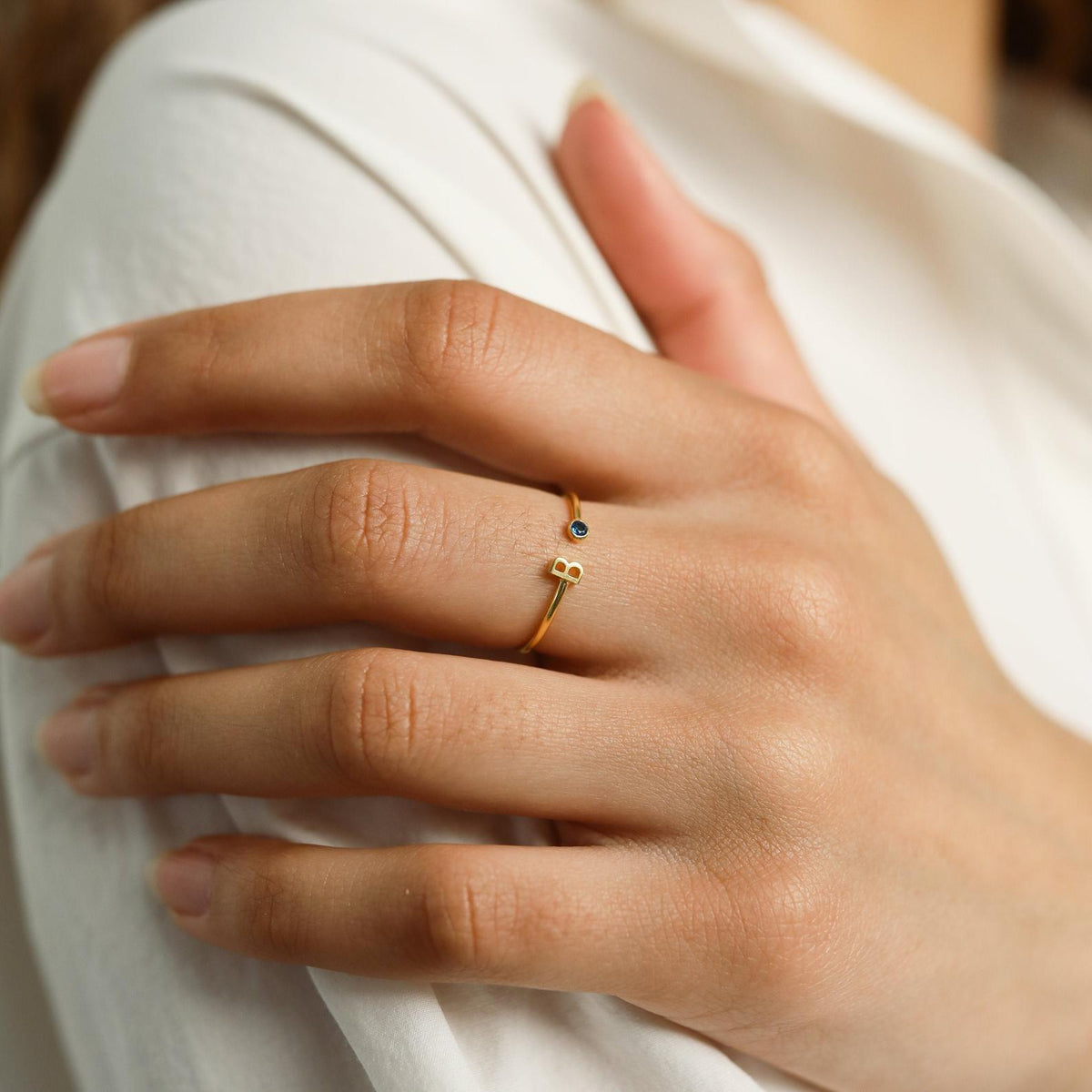 Custom initial birthstone ring from MUHVA STORE featuring a personalized initial and sparkling birthstone on a silver band.