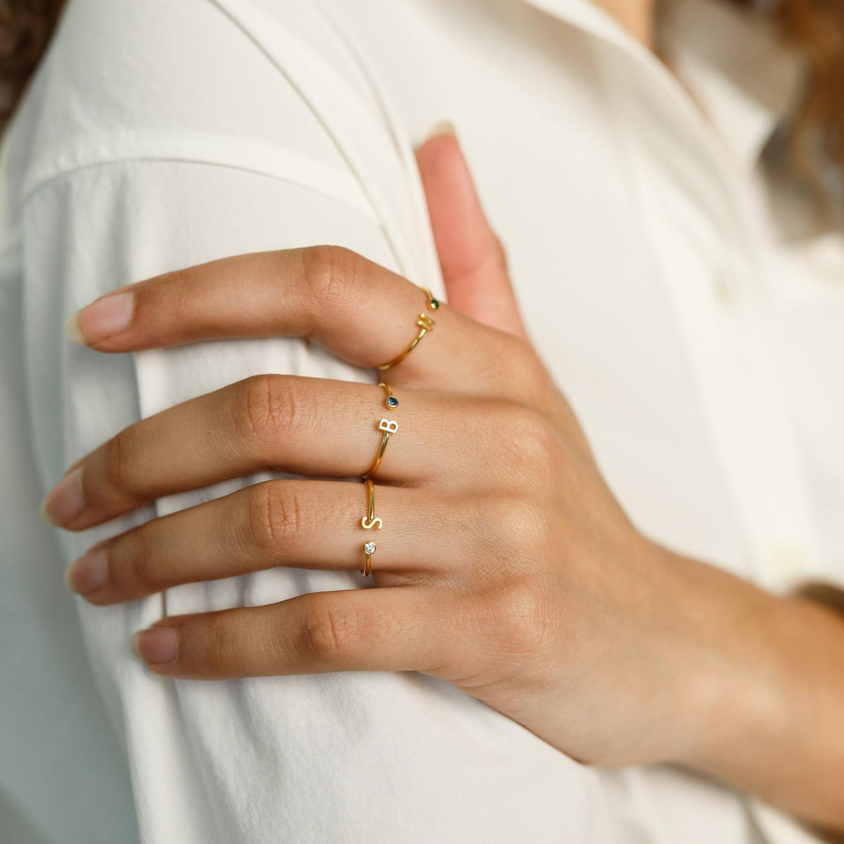 Custom initial birthstone ring from MUHVA STORE featuring a personalized initial and sparkling birthstone in a silver band.