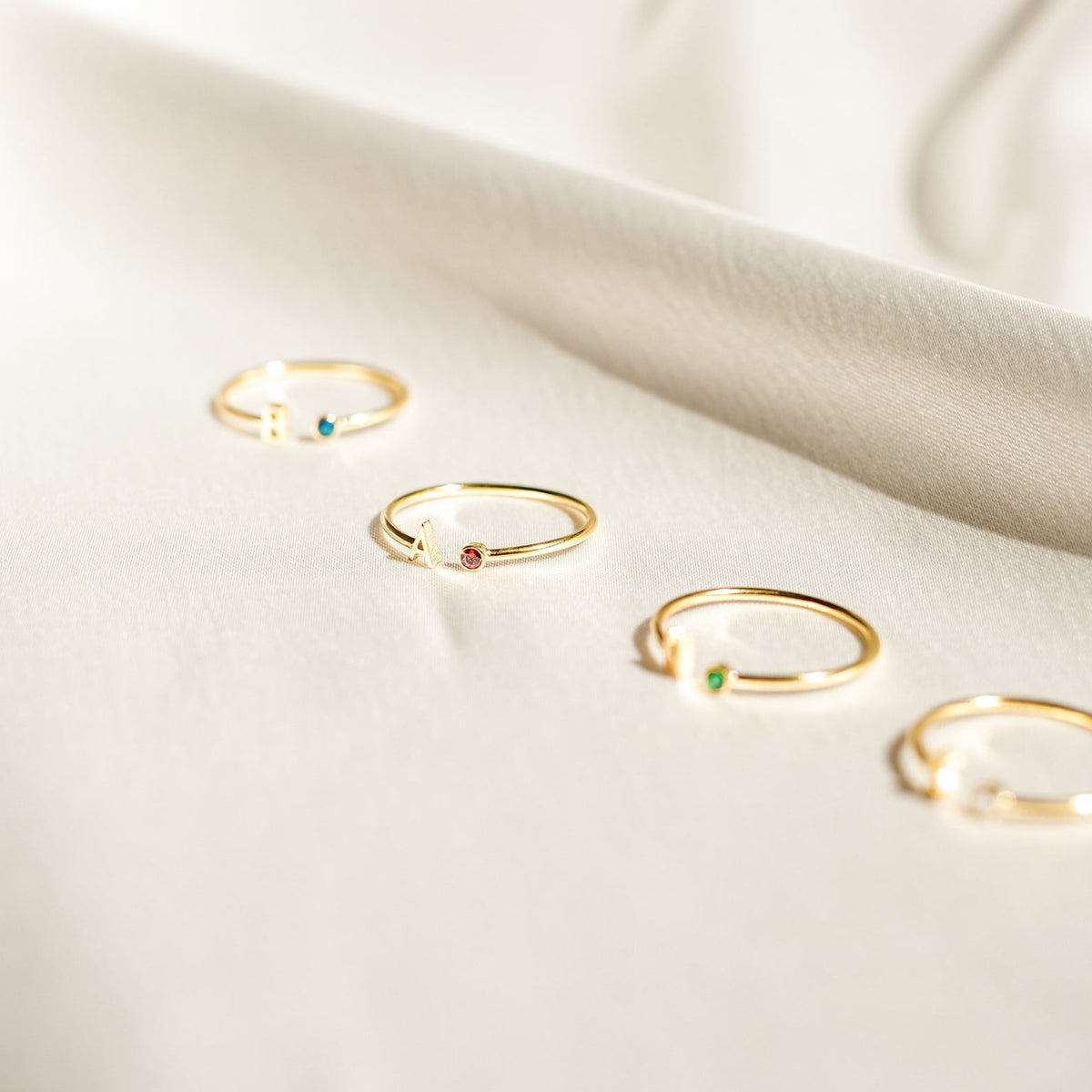 Custom initial birthstone ring by MUHVA STORE featuring a personalized initial and sparkling birthstone on a sleek band.