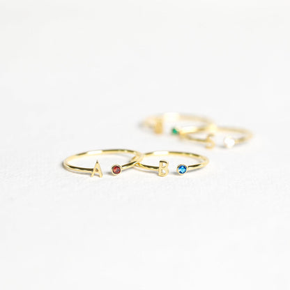 Gold custom initial birthstone ring with engraved initial and sparkling birthstone, designed by MUHVA STORE.