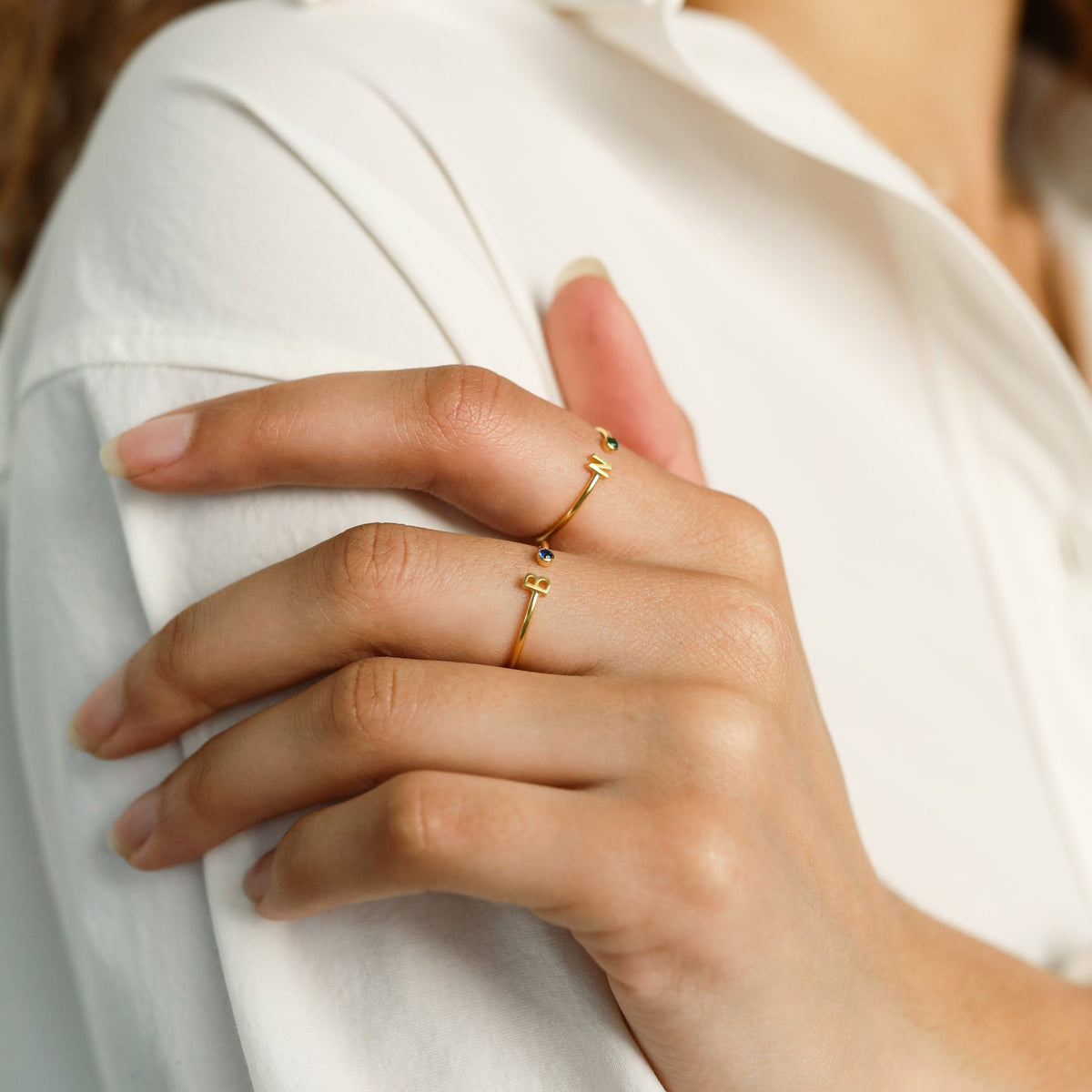 Gold custom initial birthstone ring by MUHVA STORE featuring a personalized initial and sparkling birthstone detail.
