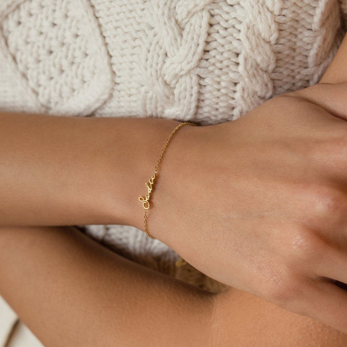Personalized name bracelet with engraved custom name, silver-tone jewelry from MUHVA STORE, close-up of the bracelet's stylish design.