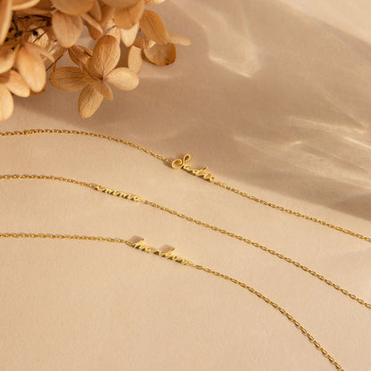 Personalized name bracelet with custom engraved name in elegant metal design, featuring adjustable chain and stylish charm.