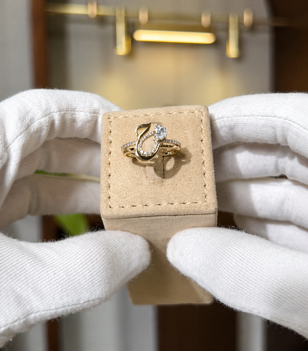 Elegant diamond initial ring by MUHVA STORE featuring a sparkling diamond accent and a personalized initial design.