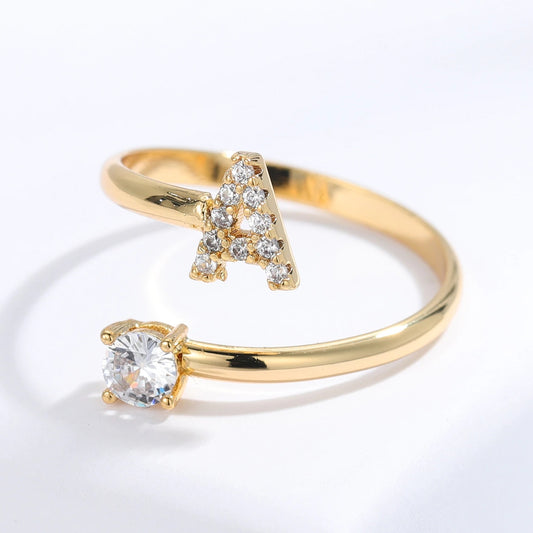 Diamond letter ring by MUHVA STORE featuring a sparkling letter design with embedded diamonds in a sleek band.