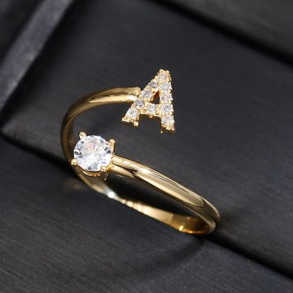 Diamond letter ring from MUHVA STORE featuring a sleek band with a sparkling diamond-encrusted letter design.
