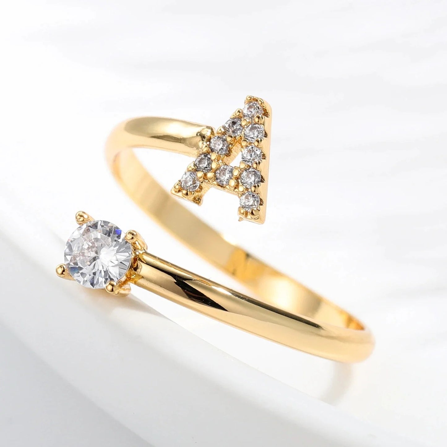 Diamond letter ring from MUHVA STORE featuring a sleek band with sparkling diamond accents and a personalized letter design.