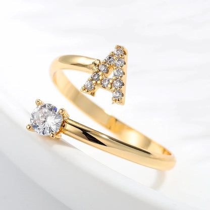 Diamond letter ring from MUHVA STORE featuring a sleek band with sparkling diamond accents and a personalized letter design.