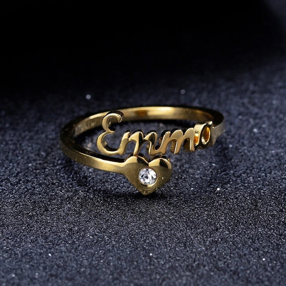 Diamond spiral name ring by MUHVA STORE featuring a personalized engraved design with sparkling diamonds on a silver band.