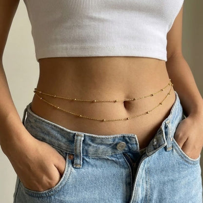 Double layer waist chain from MUHVA STORE featuring gold-tone links and intricate design, worn around the waist.