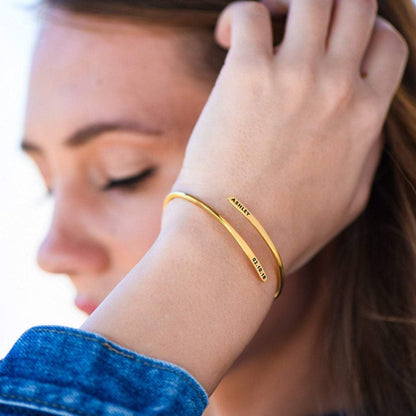 Personalized name bangle bracelet from MUHVA STORE with custom engraved name, sleek silver design, and smooth finish.