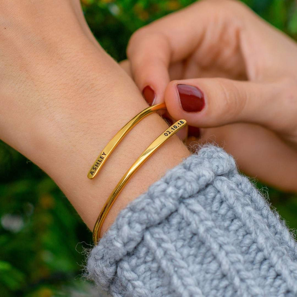 Personalized name bangle bracelet from MUHVA STORE with custom name engraving on sleek metal jewelry piece.