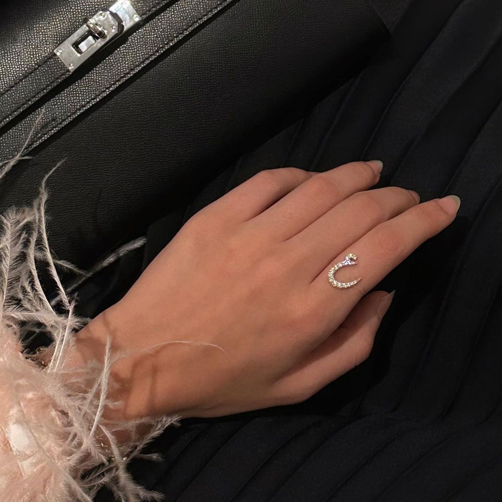 Diamond Arabic letter ring from MUHVA STORE featuring a sleek band with a shimmering diamond-accented Arabic character.