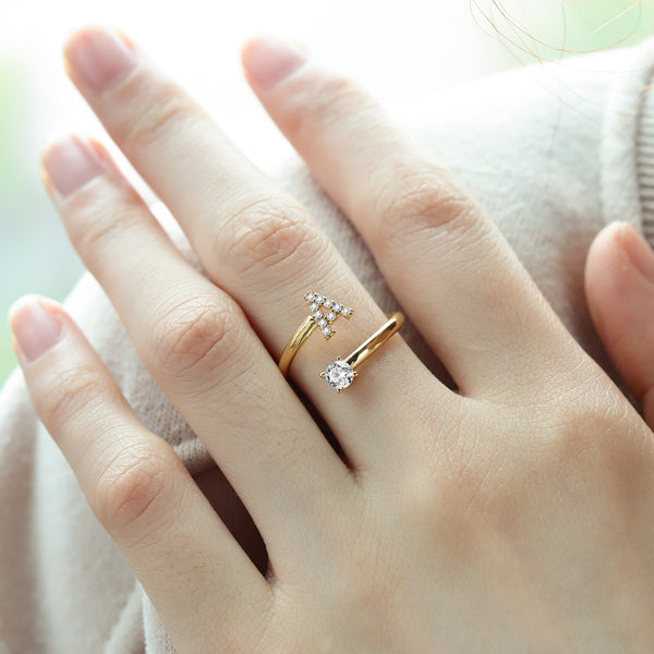 Pair of initial letter rings from MUHVA STORE, featuring engraved letter "R" on sleek silver bands.