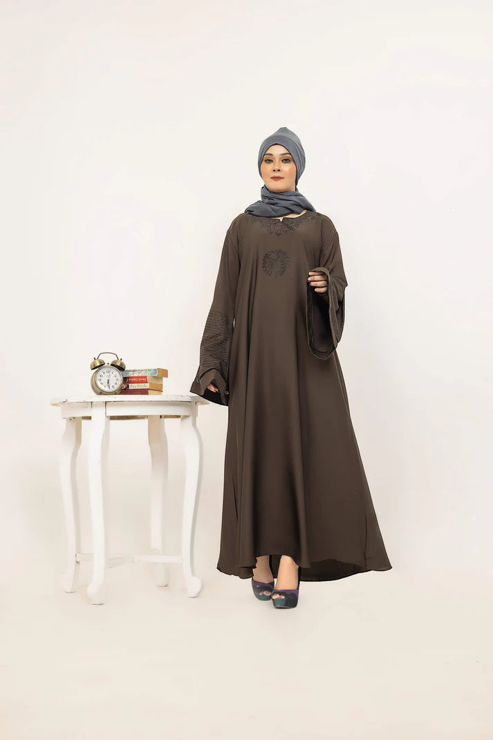 MUHVA STORE SHOROOQ in vibrant colors with intricate patterns, displayed on a mannequin against a neutral background.