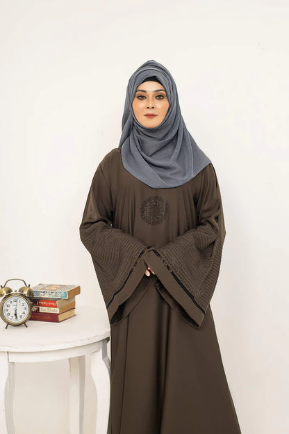 Shorooq by Muhva Store, stylish woven rug with intricate patterns and warm earthy tones, displayed on a wooden floor.