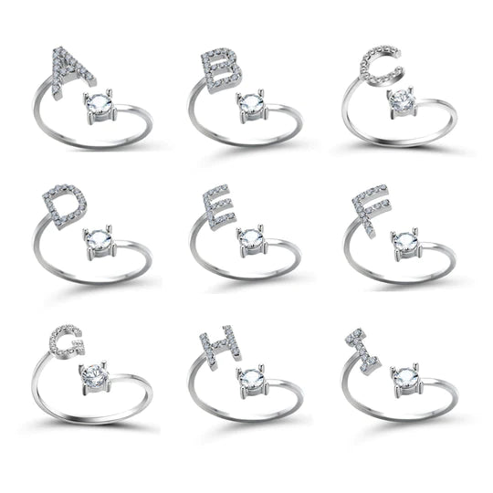Pair of initial letter rings from MUHVA STORE featuring engraved letter "R" designs in silver-tone metal.