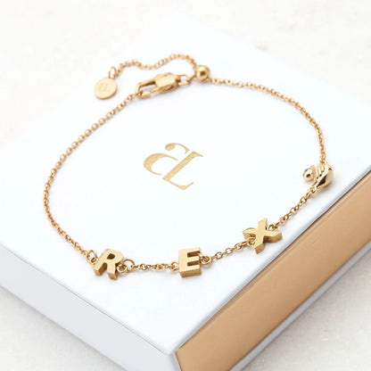 Gold-coated Stacy name bracelet from Muhva Store featuring custom engraving and gift box, elegant jewelry accessory.