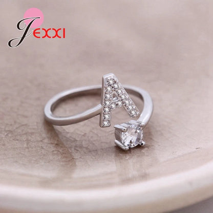 Pair of gold initial letter rings from MUHVA STORE, featuring customizable alphabet design in a sleek, modern style.